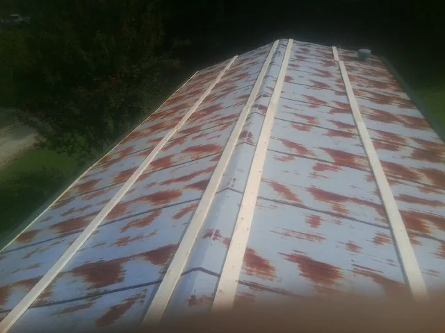 Rusted metal roof panels with new wood purlins before replacement — Storm Damage Roof Repair in Wichita by Roofing Brothers